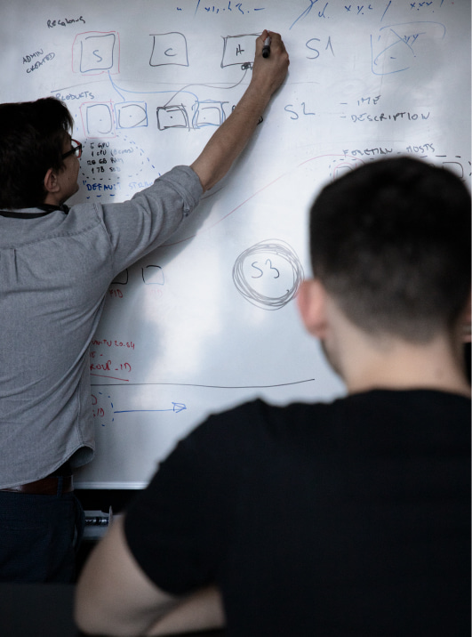 Man writting on the glass scrum board